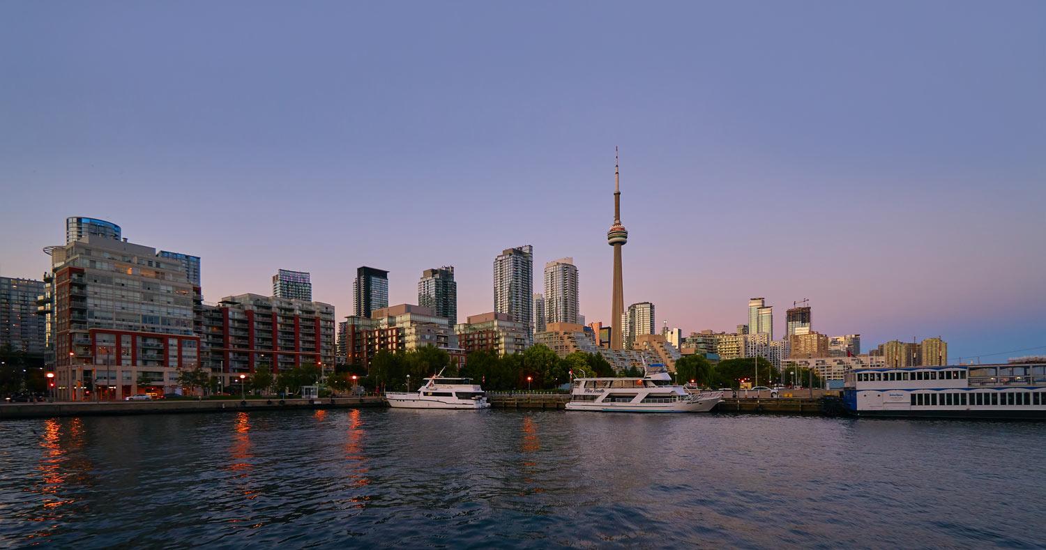 the Toronto city skyline with the lake at sunset