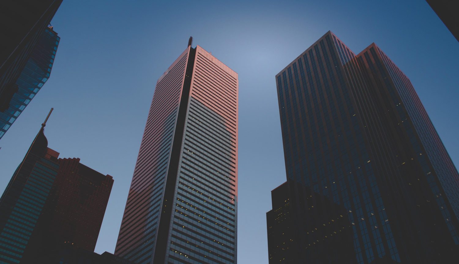 upward view of a Toronto high rise office building with blue sky in the background